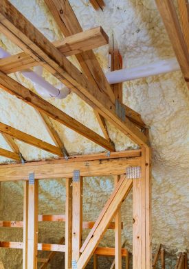 Foam plastic insulation installed in the sloping ceiling of a new frame house.