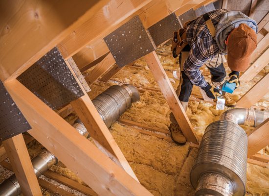 Heating and Cooling Technician Insulating Ventilation Pipeline Using Thermal Tape.