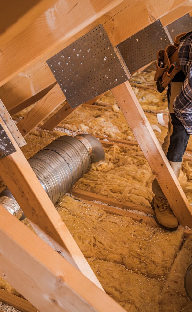 Heating and Cooling Technician Insulating Ventilation Pipeline Using Thermal Tape.